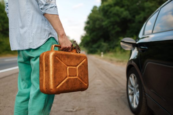 Man holds petrol canister, car breakdown, out of gas. Broken automobile or problem with vehicle, trouble with auto on highway